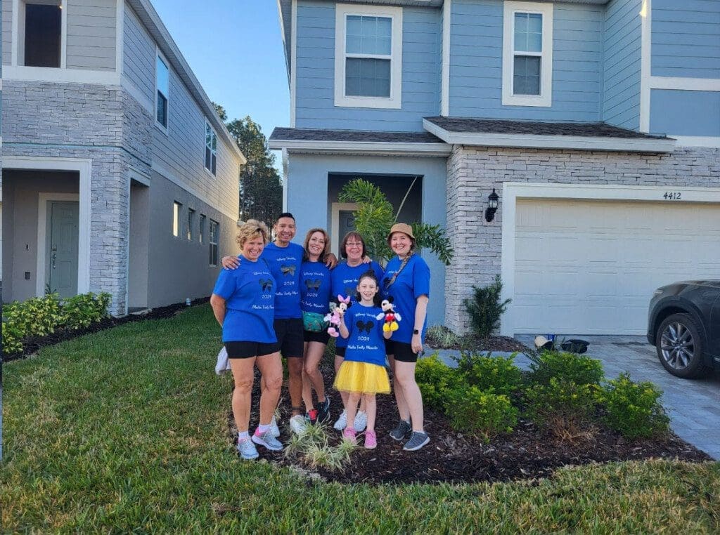Our family standing in front of a beautiful house, enjoying our Florida vacation rental experience at Chillax Inn.